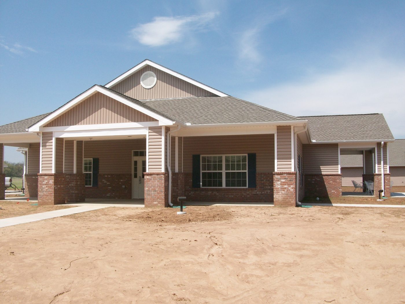 Exterior of Perkins Assisted Living Center, a brick and vinyl-sided residential care building