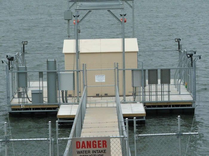 Water intake structure on a lake with security fencing