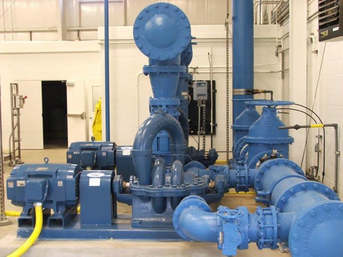 Large blue pump equipment inside a mechanical room